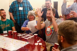 ELM board member and Instigator Margaret Moreland leads the board game “Beat the Eschaton - Full Inclusion Version” board game created by Bennett Falk to tell the history of our movement. You can see this year’s “Kindle the Flame” T-shirt on Andy Flatt (far left). 